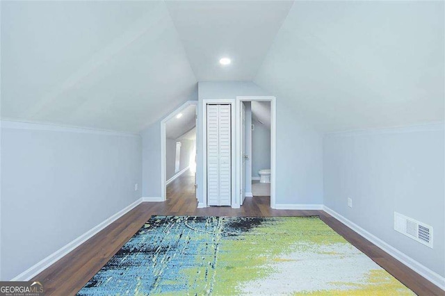 bonus room with visible vents, lofted ceiling, baseboards, and wood finished floors