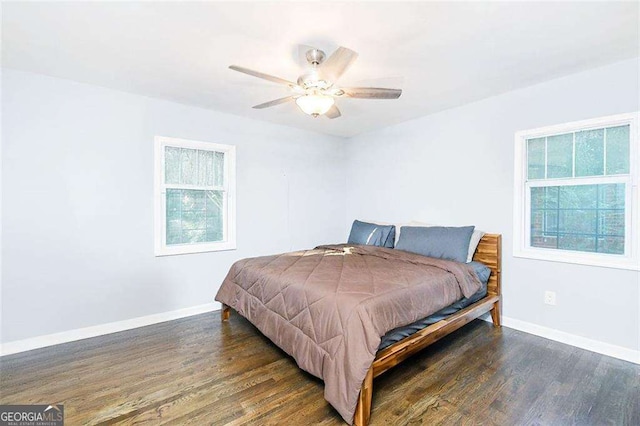 bedroom featuring wood finished floors, baseboards, and ceiling fan