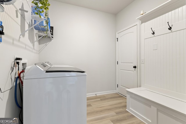 laundry room with laundry area, baseboards, separate washer and dryer, and light wood finished floors