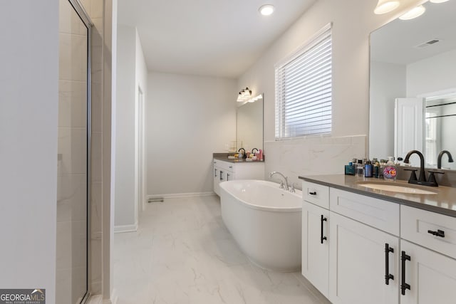 bathroom with marble finish floor, a soaking tub, visible vents, a stall shower, and a sink