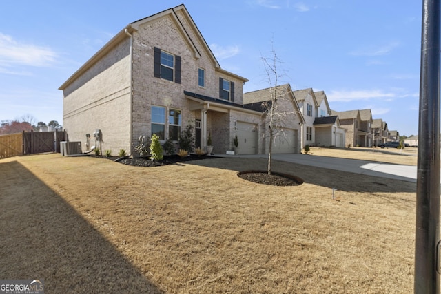 traditional-style home with brick siding, concrete driveway, an attached garage, fence, and cooling unit