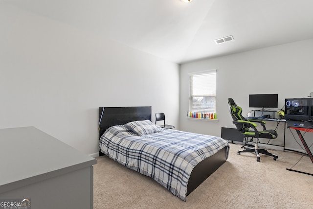 bedroom featuring vaulted ceiling, carpet floors, visible vents, and baseboards