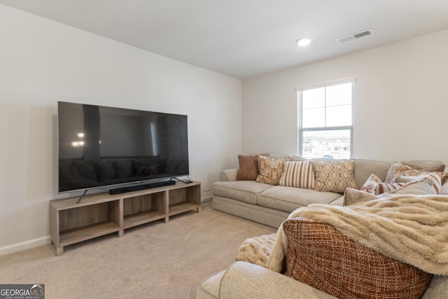 living area featuring carpet floors, visible vents, and baseboards