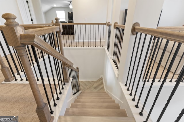 stairs featuring carpet and baseboards