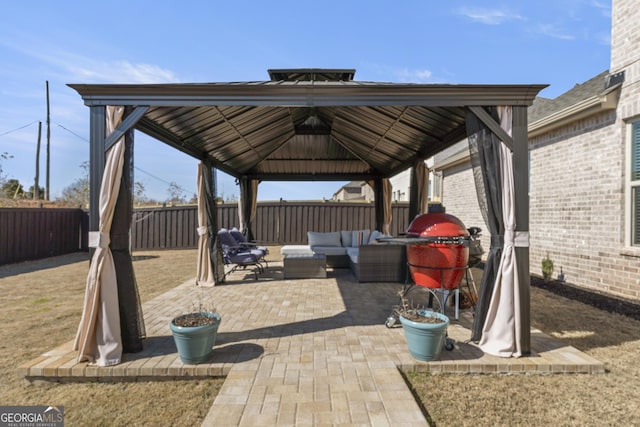 view of patio / terrace with outdoor lounge area, a fenced backyard, and a gazebo