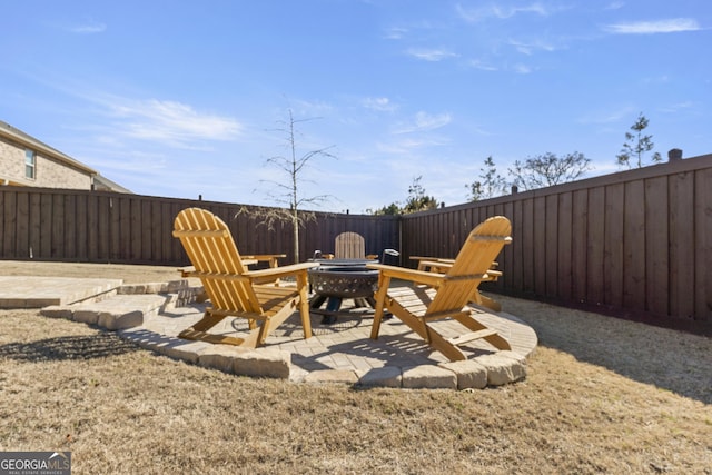 view of patio featuring a fenced backyard and a fire pit