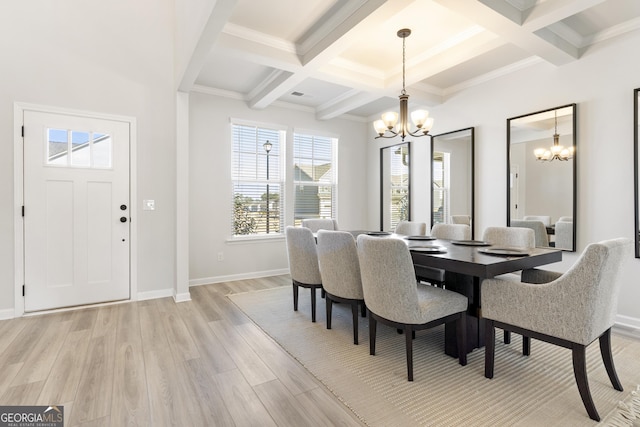 dining area with light wood-type flooring, beam ceiling, baseboards, and a notable chandelier