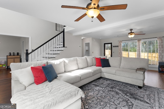 living room featuring a ceiling fan, stairway, and dark wood-style flooring