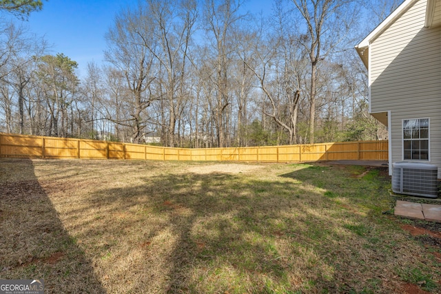 view of yard with cooling unit and a fenced backyard