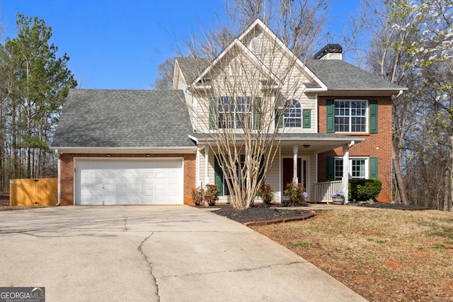 traditional-style home featuring a garage, driveway, a shingled roof, a porch, and brick siding