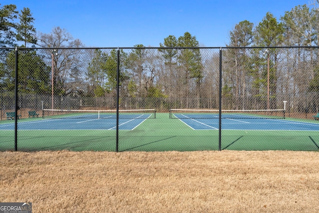 view of sport court with fence