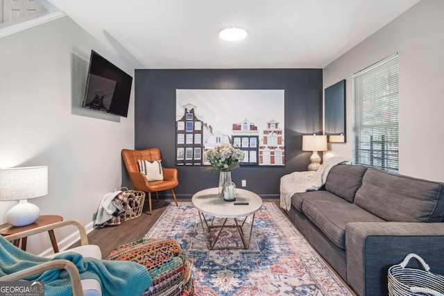 living area featuring wood finished floors and baseboards