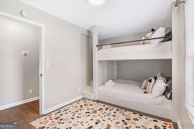 bedroom featuring wood finished floors and baseboards