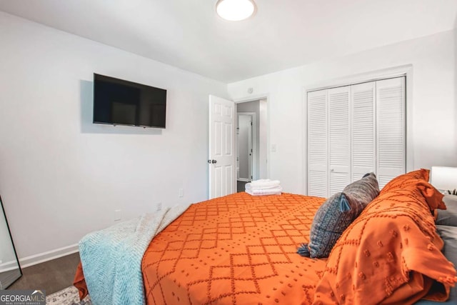 bedroom featuring baseboards, a closet, and wood finished floors