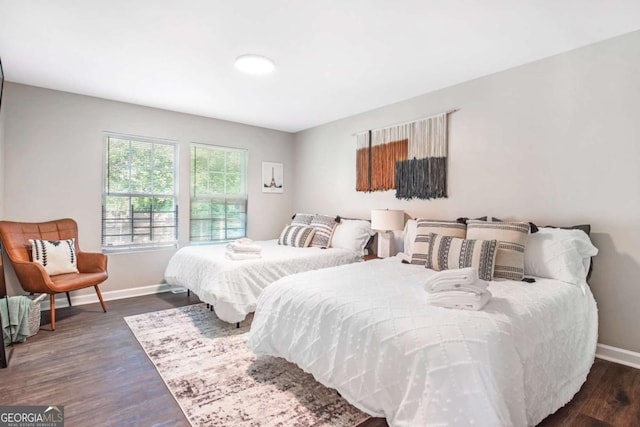 bedroom featuring baseboards and wood finished floors