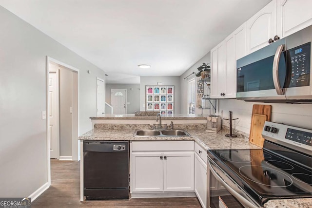 kitchen featuring stainless steel appliances, light countertops, a sink, and white cabinetry