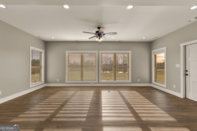 unfurnished living room featuring visible vents, baseboards, dark wood-style flooring, and recessed lighting