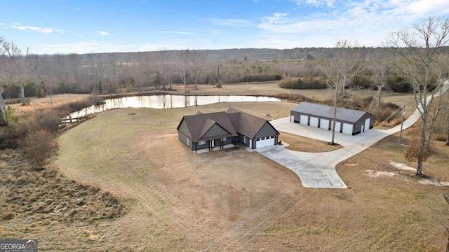 drone / aerial view featuring a water view and a view of trees