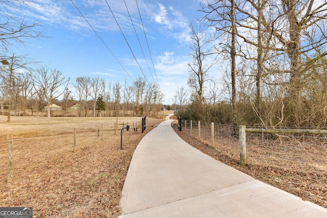 surrounding community featuring fence and a rural view