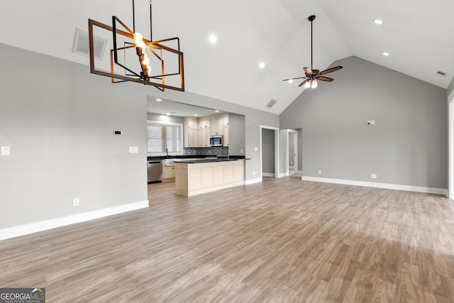 unfurnished living room with light wood finished floors, baseboards, visible vents, and ceiling fan with notable chandelier