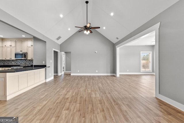 unfurnished living room featuring visible vents, light wood-style flooring, and baseboards