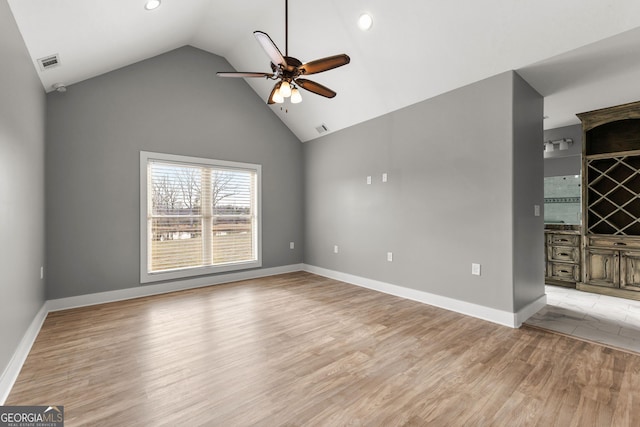 interior space with light wood-style floors, baseboards, visible vents, and a ceiling fan