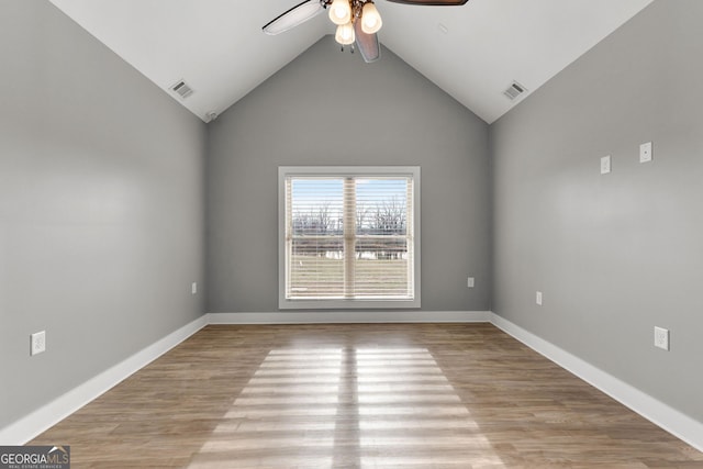 empty room with light wood-style flooring, visible vents, and baseboards