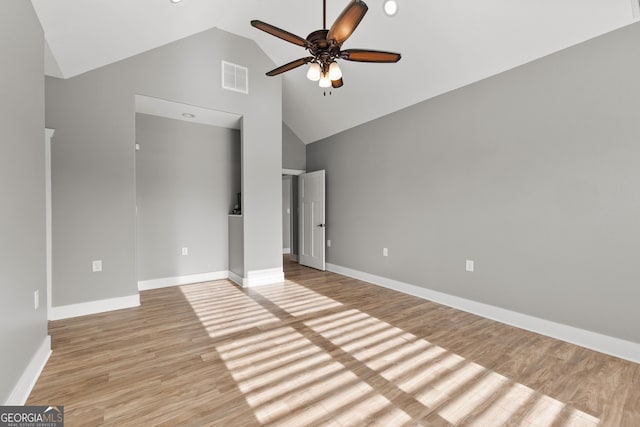 unfurnished bedroom featuring high vaulted ceiling, baseboards, visible vents, and light wood finished floors