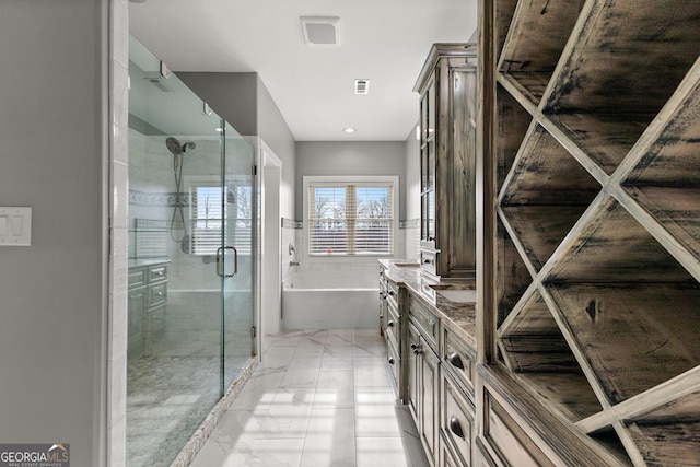 full bathroom with marble finish floor, double vanity, a soaking tub, visible vents, and a stall shower