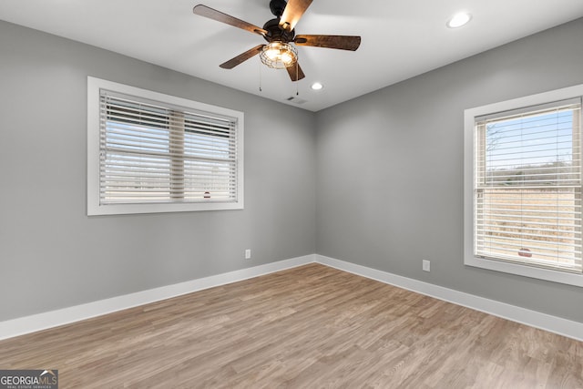 spare room with visible vents, baseboards, and a wealth of natural light