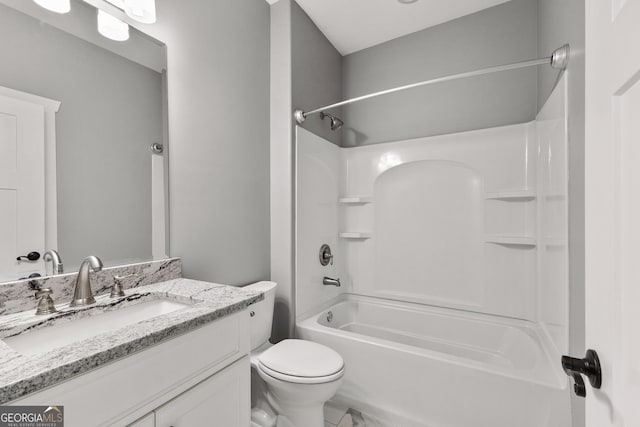 bathroom with washtub / shower combination, vanity, and toilet