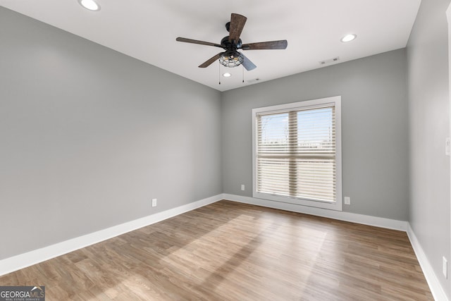 spare room with baseboards, visible vents, ceiling fan, light wood-style floors, and recessed lighting