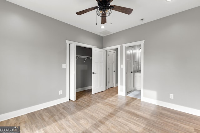 unfurnished bedroom with light wood-type flooring, baseboards, a closet, and recessed lighting