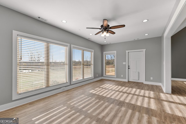 unfurnished living room with recessed lighting, visible vents, light wood-style flooring, and baseboards