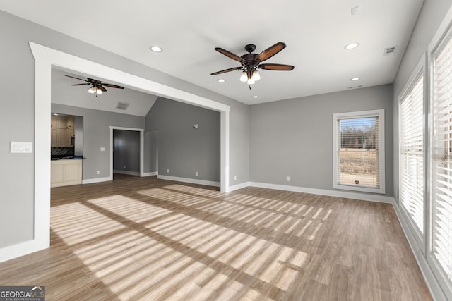 unfurnished living room with light wood-style floors, visible vents, and recessed lighting