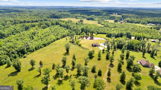 drone / aerial view featuring a wooded view