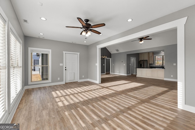 unfurnished living room featuring baseboards, light wood finished floors, a ceiling fan, and recessed lighting