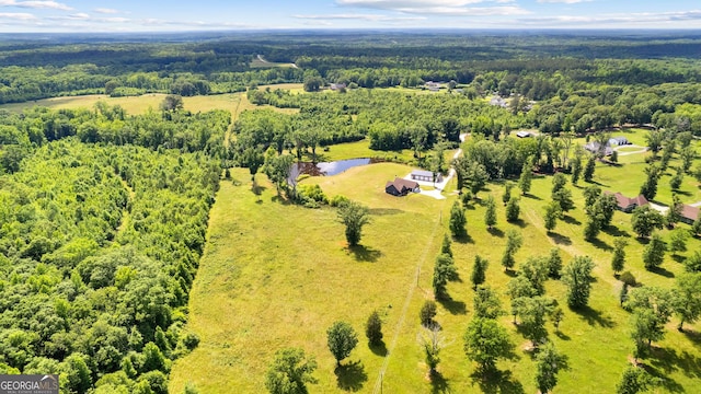 birds eye view of property with a forest view