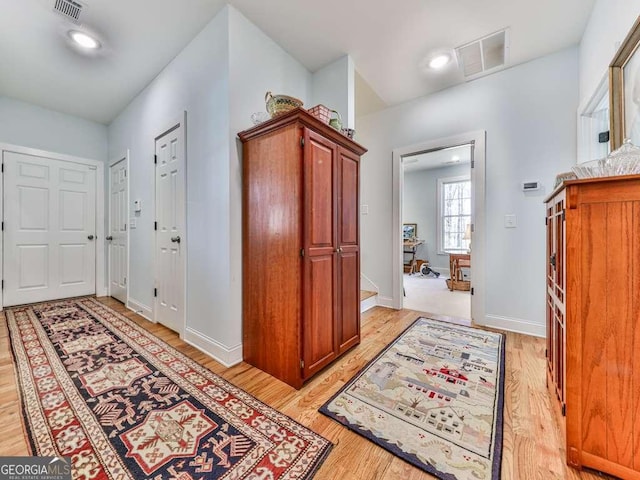 entrance foyer featuring light wood finished floors, visible vents, and baseboards