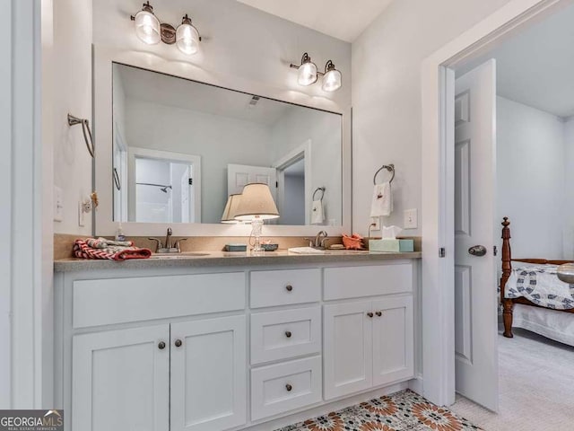 full bath featuring double vanity, a sink, and connected bathroom