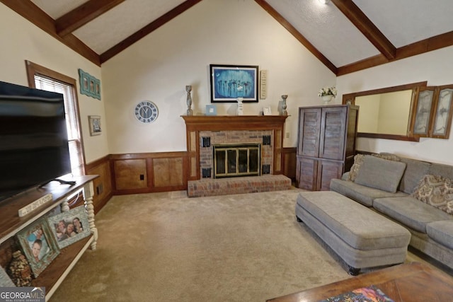 carpeted living room featuring high vaulted ceiling, wainscoting, beam ceiling, and a brick fireplace