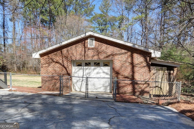 exterior space featuring aphalt driveway, a gate, and fence