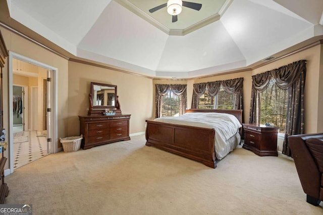 bedroom with visible vents, ceiling fan, crown molding, a raised ceiling, and light colored carpet