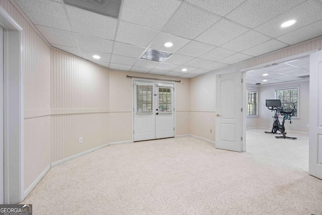 below grade area featuring recessed lighting, a paneled ceiling, baseboards, and carpet floors