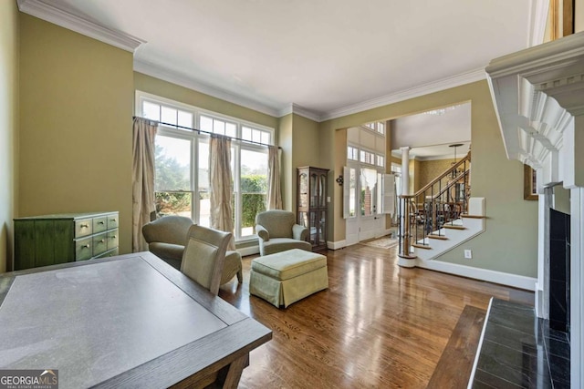 interior space with stairway, baseboards, wood finished floors, and crown molding