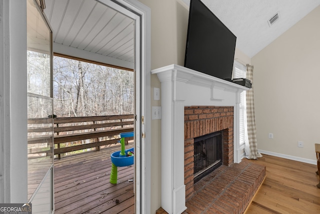 interior space with a brick fireplace and visible vents