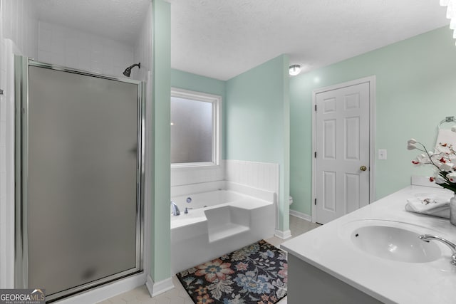 full bath with toilet, a garden tub, a textured ceiling, a shower stall, and a sink