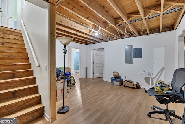 workout area with wood finished floors and electric panel