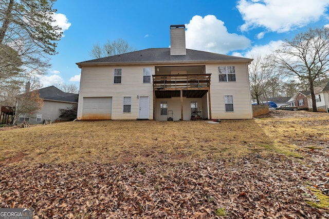 rear view of property featuring a garage and a chimney