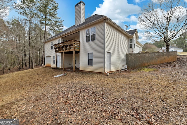 rear view of property featuring a chimney